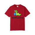 Cute bookworm graphic t-shirt with green worm wearing glasses reading a blue book, printed on periwinkle Comfort Colors garment-dyed cotton unisex tee for book lovers