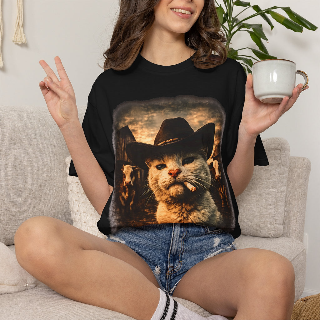 Black t-shirt with photorealistic white cat wearing a black cowboy hat and smoking, vintage sepia Western ranch scene with cattle, funny graphic tee